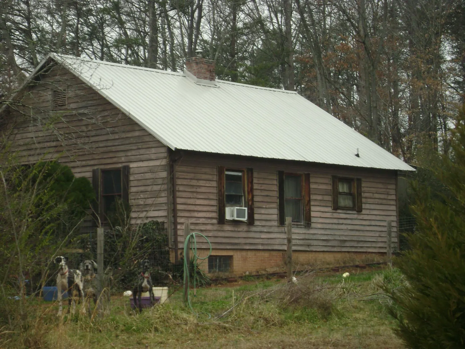 White metal roof on an old wood sided farmhouse, from a Metal Roof Installation job in Sherwood